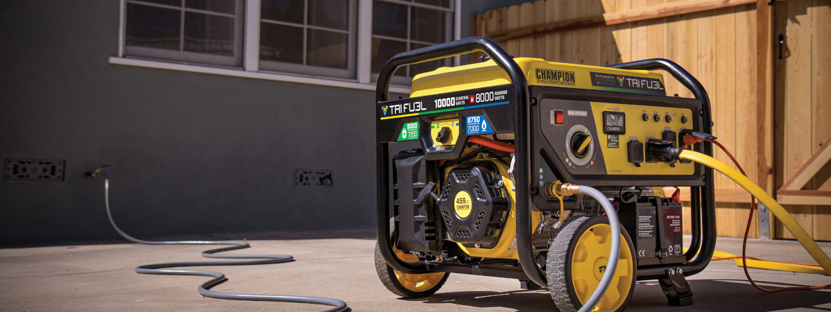 A Champion Tri Fuel Generator on a driveway connected to the home's natural gas supply and the home transfer switch inlet box.