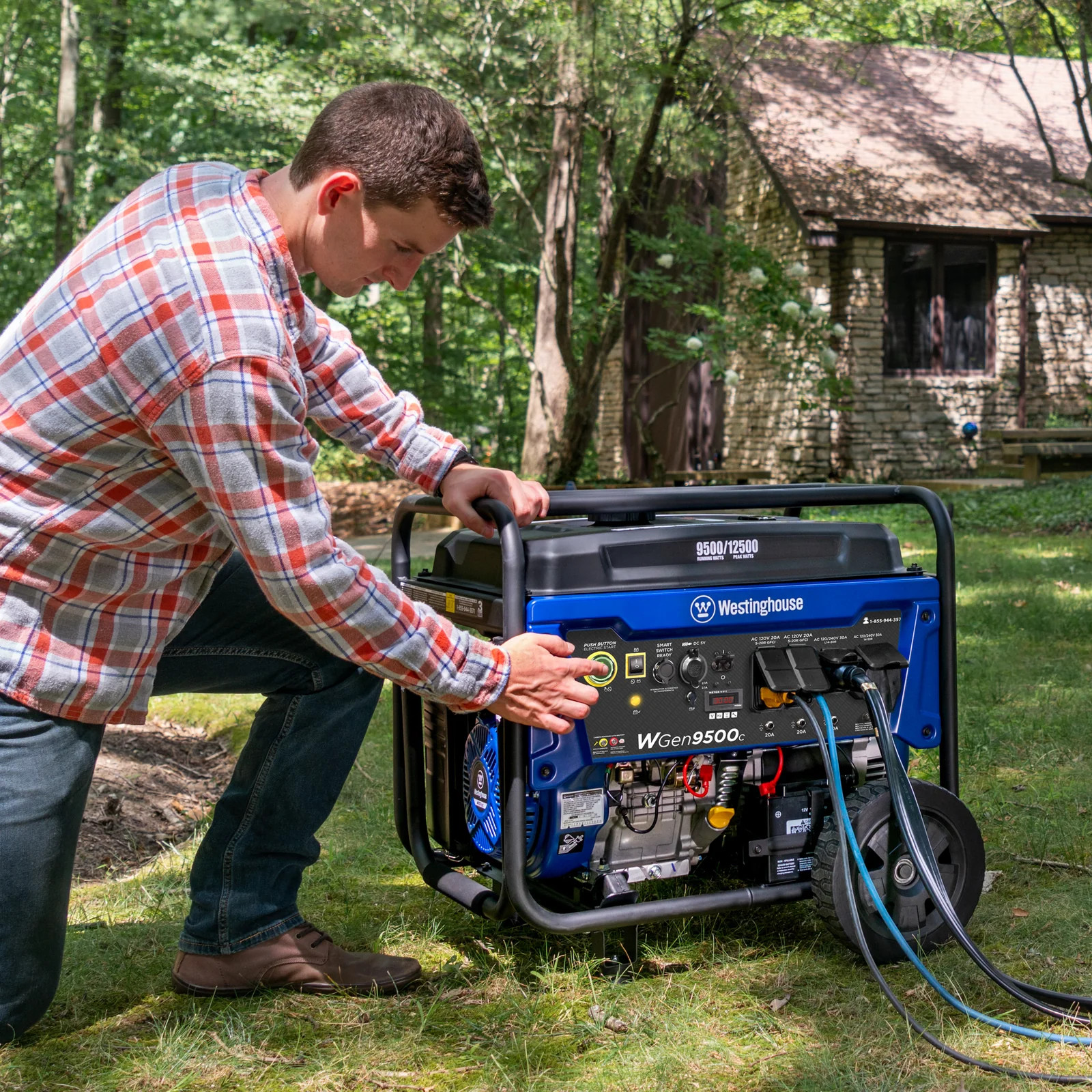A man starts a Westinghouse Portable Generator with extension cords plugged into outlets.
